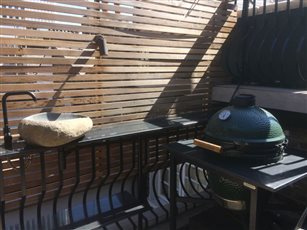 Outdoor kitchen under louvred pergola for penthouse