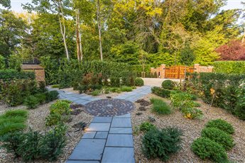 Contemporary parterre forms a new entrance garden, and new automated hardwood gates create a stylish arrival. 