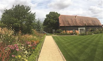 Rear Garden with large lawn, pathways and colour border.
