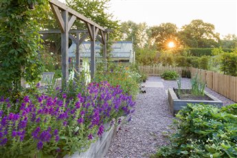 A kitchen garden has been built that includes an oak pergola over a private seating area.