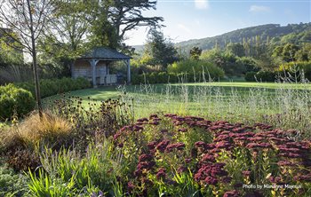 Timber framed gazebo in a country garden in West Sussex