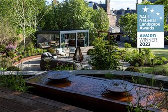 BALI Award winner 2023 - The design response centered around a large circular patio, positioned for all day sun, wrapped with tiers of corten steel to create an ‘amphitheatre’ of terraced planting. 