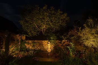 Garden lighting design and installation by Mark Packham, Garden and Landscape Lighting Designer at Garden Spark 
Statue of Aphrodite and flint walls gently illuminated 